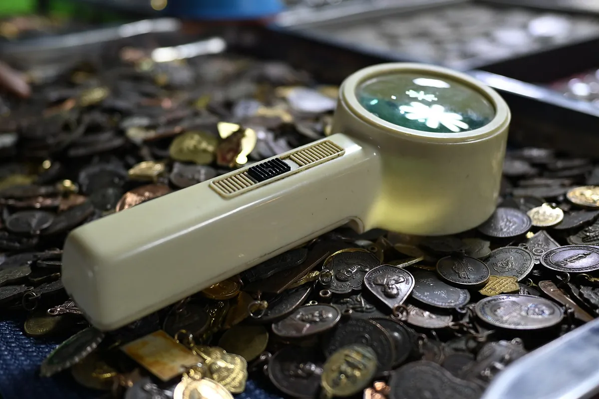 A work table: loupe, coins, maps